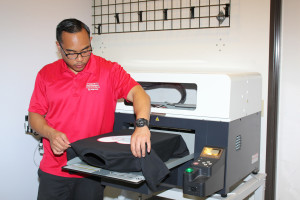 Custom T-Shirt printing on a direct-to-garment printer.